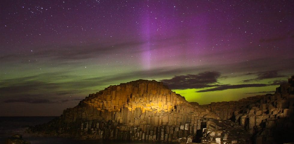 Purple Pillars and Green Auroral Glow over the Giant's Causeway in Northern Ireland captured by Martin McKenna and shared through spaceweather.com