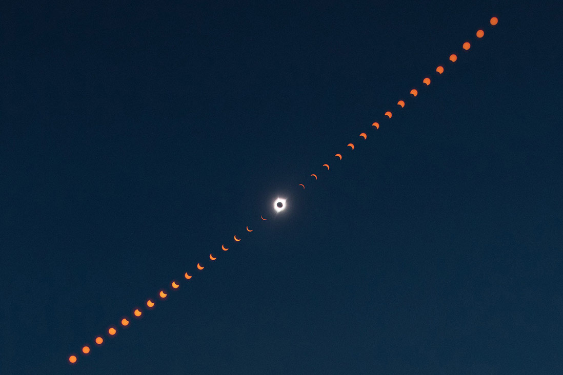 This image is a composite photograph that shows the progression of the total solar eclipse over Madras, Oregon.
